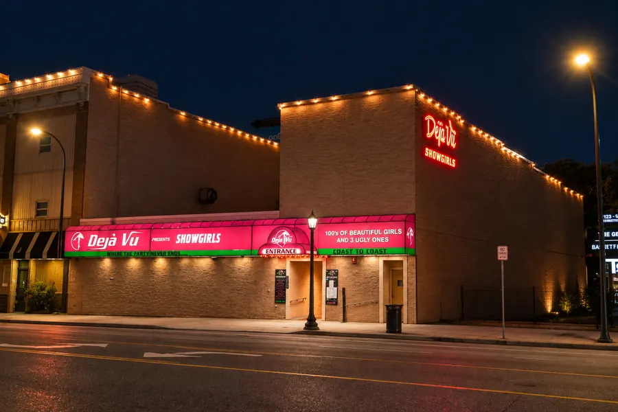 Déjà Vu Showgirls exterior at night — neon sign and entrance, Minneapolis