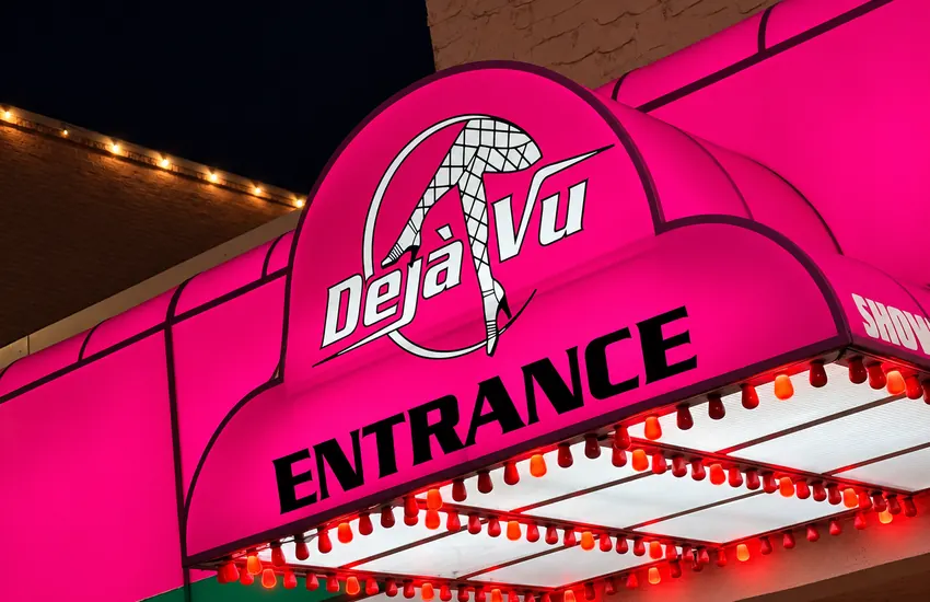 The pink Déjà Vu entrance awning with marquee bulbs