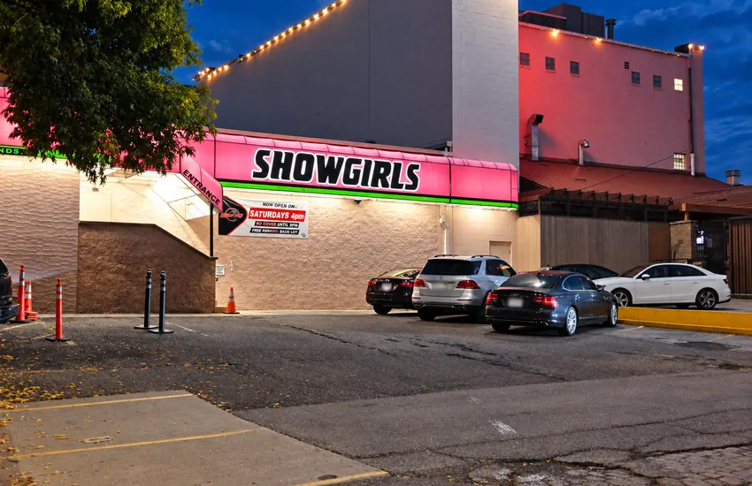 Free rear parking lot behind the club — Showgirls wall and back entrance