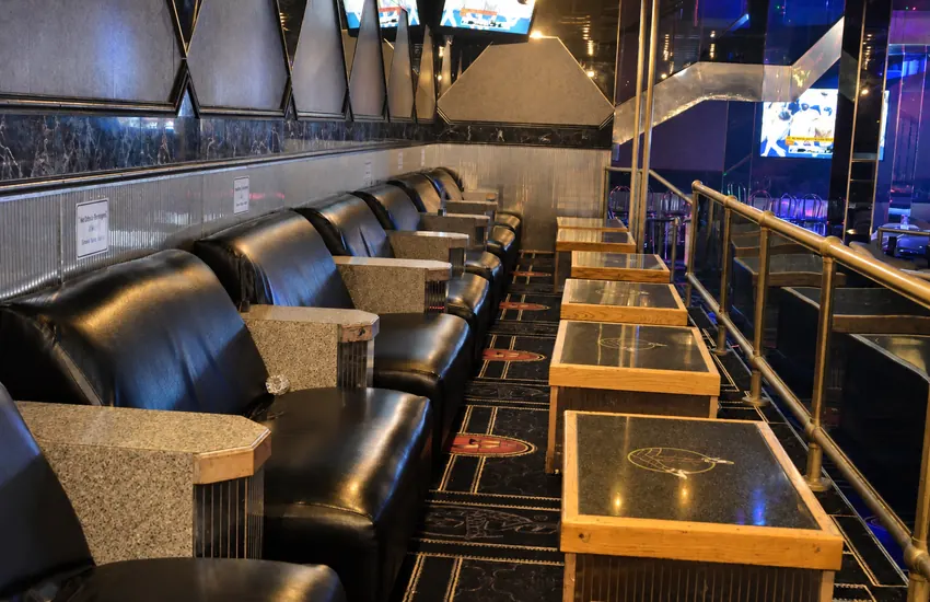 Leather seating row along the rail overlooking the floor