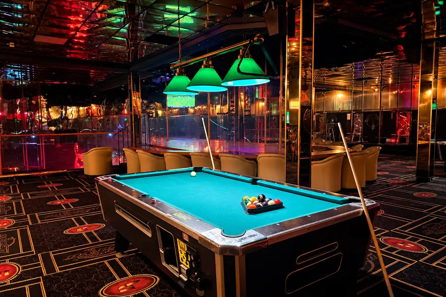 Pool table and lounge seating by the stage at Déjà Vu Minneapolis