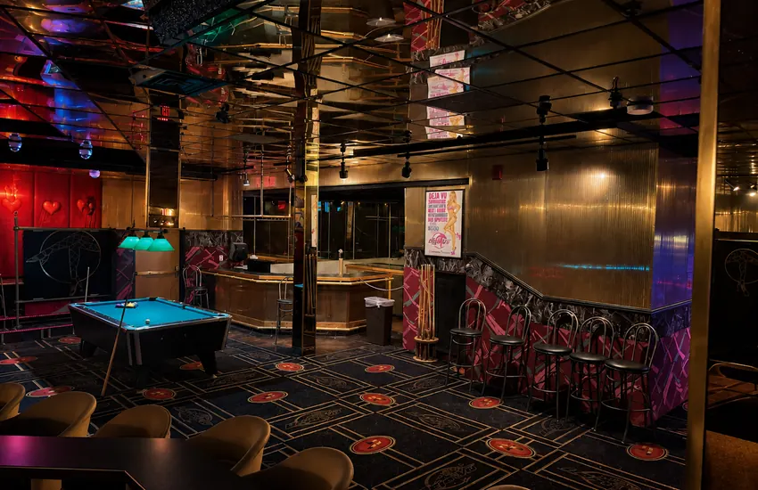 Upstairs bar corner with pool table and vintage Déjà Vu posters