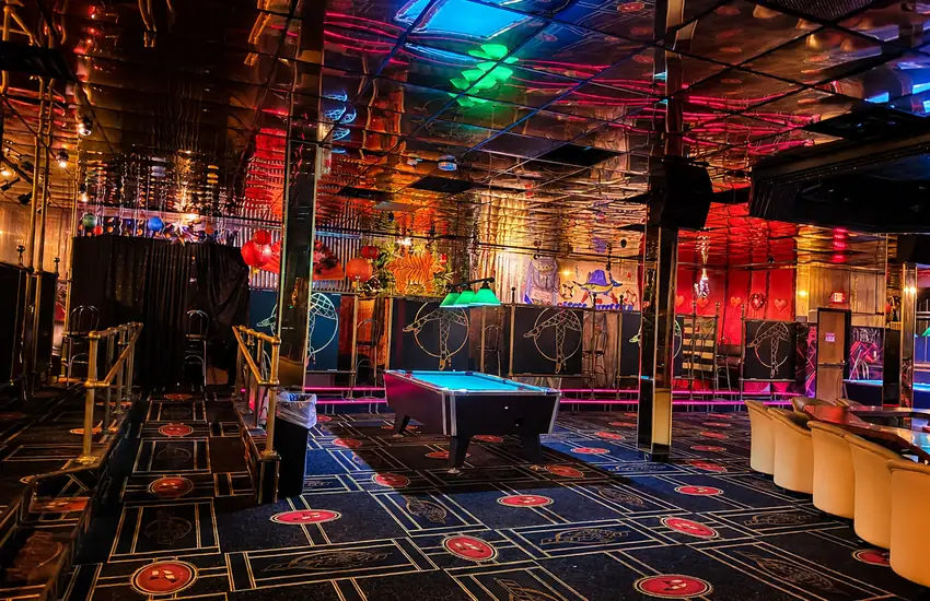 Upstairs lounge — pool table, lanterns, and mirrored ceiling